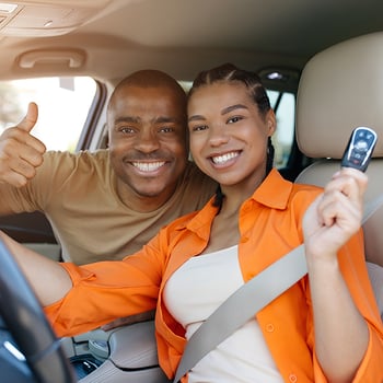 happy couple in their new car