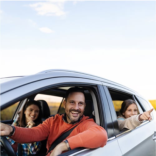 Happy middle aged man in new car