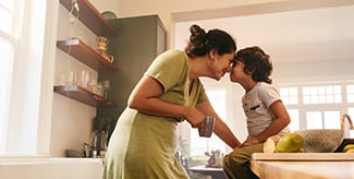 Affectionate mother touching noses with her young son