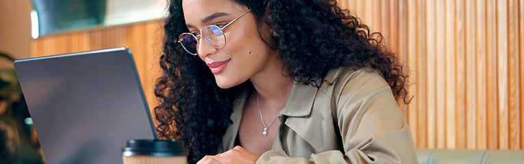 Cafe, thinking and woman with a laptop, relax and connection with inspiration, email and planning.