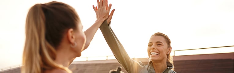 Celebrating Fitness Friends Sharing Joyful HighFives After Completing Their Workout Session