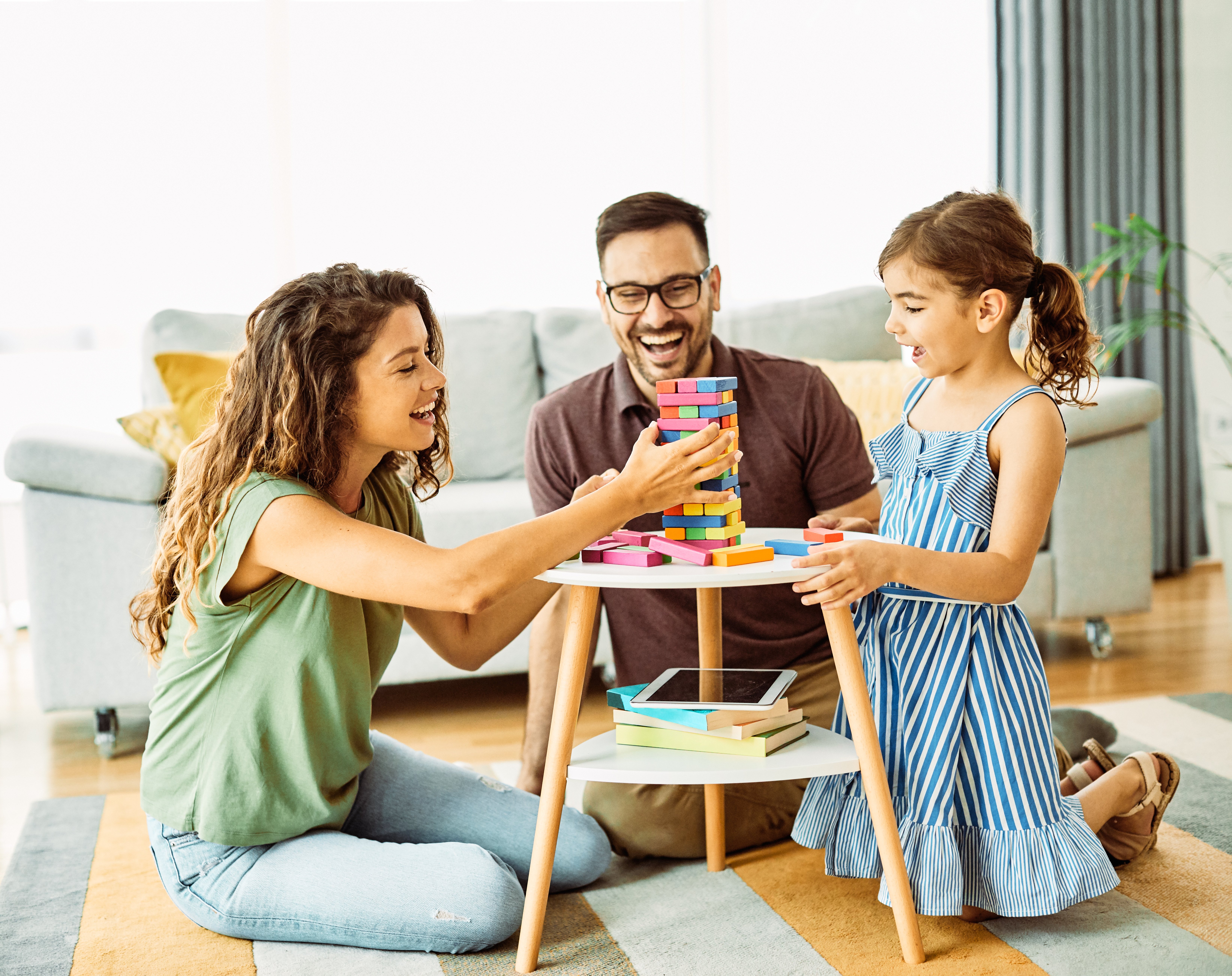 Child daughter family happy mother father board game palying playing fun together-1