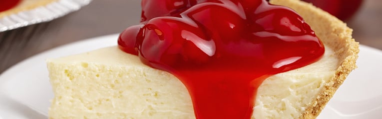 Classic slice of plain chesecake topped with cherry topping