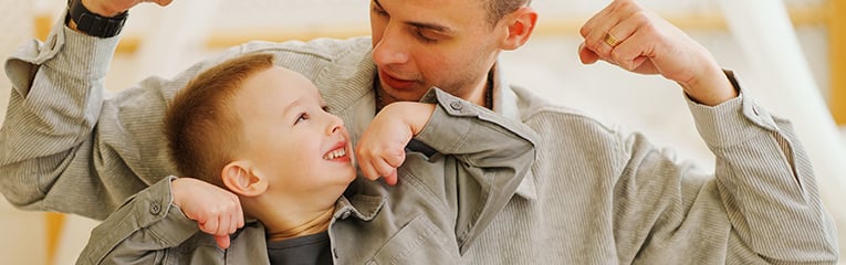 Dad playing with his son and joking