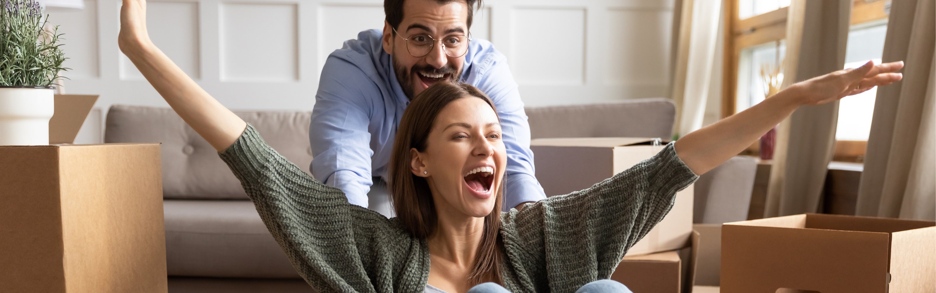 Happy family celebrating moving day, having fun at home