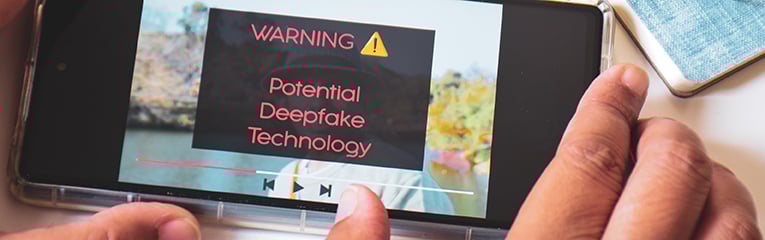 Mobile phone displaying warning message of an artificial video using deepfake technology-1