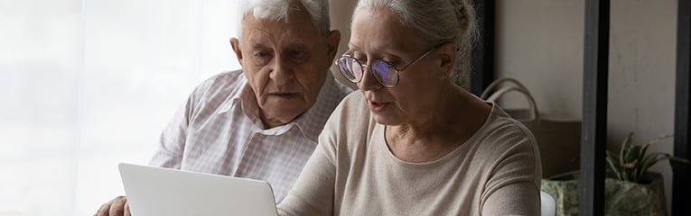 Senior married couple paying taxes, domestic bills, insurance fees