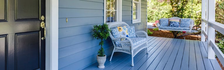 This-home-improvememt-project-includes-a-new-blue-door,-white-railing-and-painted-blue-deck.