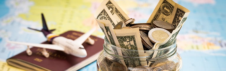 Travel budget concept with compass, passport and aircraft toy