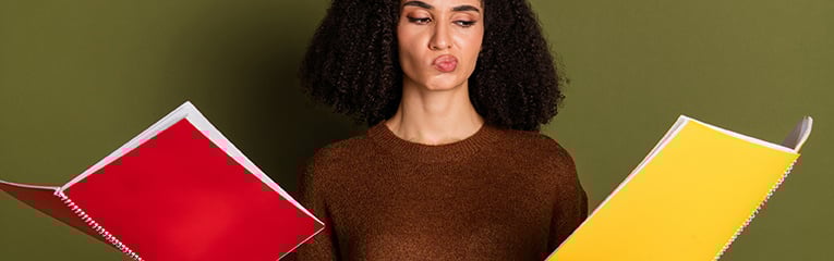 Woman choosing between two folders