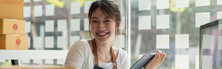 Young Asian woman smiles at office