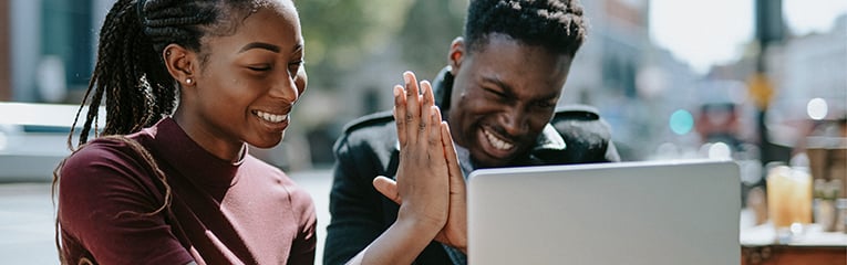 Young adults giving each other a high five