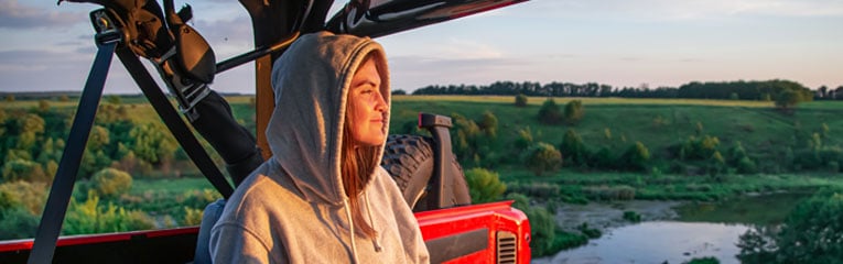Young-woman-purchased-payment-protection-insurance-and-is-relaxing-in-the-back-of-her-jeep.