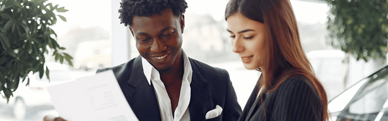 car dealership reviewing 0 apr deal and rebate offer