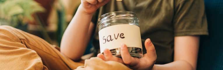 kids-savings-account-helps boy-with-savings-jar