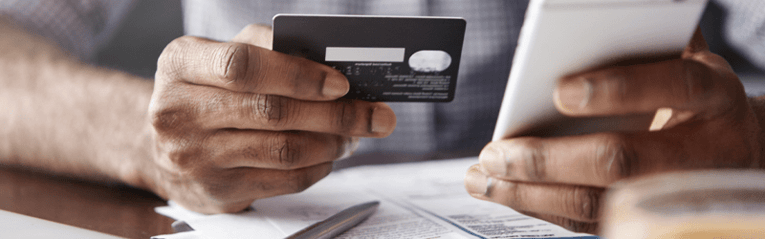 man puchasing on phone with credit card