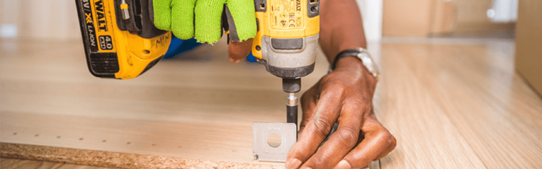 man using a heloc to pay for updates to his home using a drill