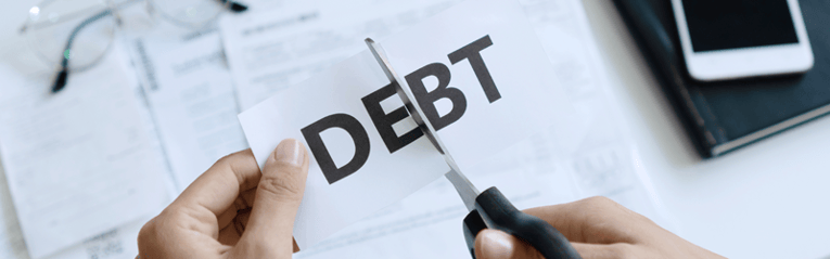 scissors cutting the word debt
