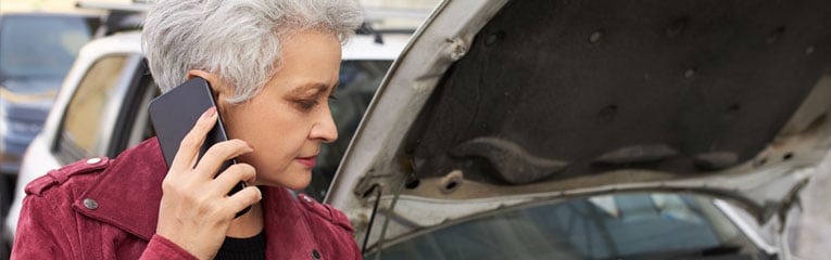 stranded-older-woman-on-her-phone-time-for-car-shopping-peach-state-can-help