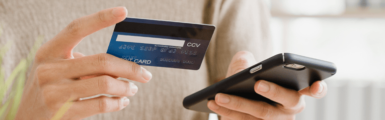 woman on phone with credit card