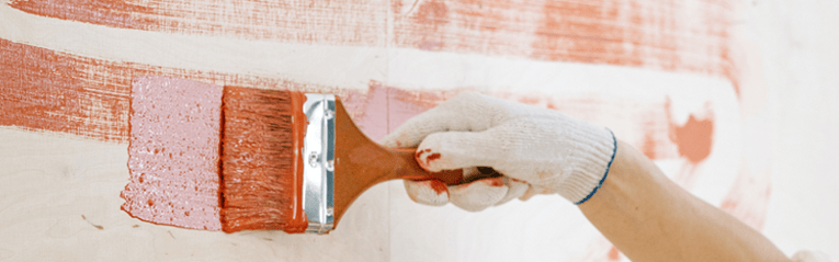 woman painting her home using a heloc