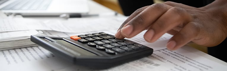 Close up of african american man with calculator checking bills