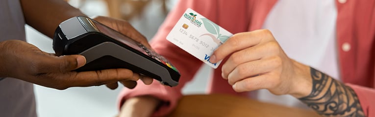 Close up picture of mans hand holding credit card