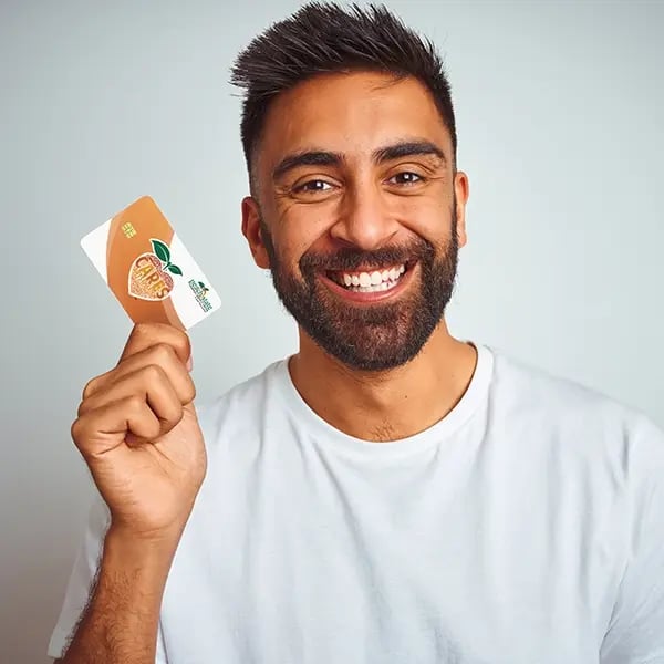 Young man holds up PSFCU visa debit card