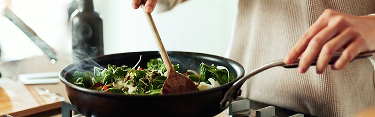 Diet, nutrition and girl with frying pan, vegetables and meal prep for dinner in home.