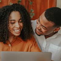 Couple smile while searching for debt consolidation options