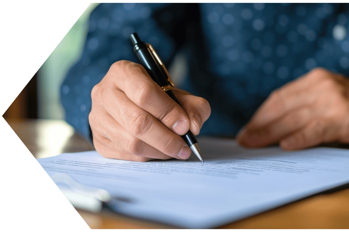 Hands signing a wire transfer to send money from their Peach State FCU account