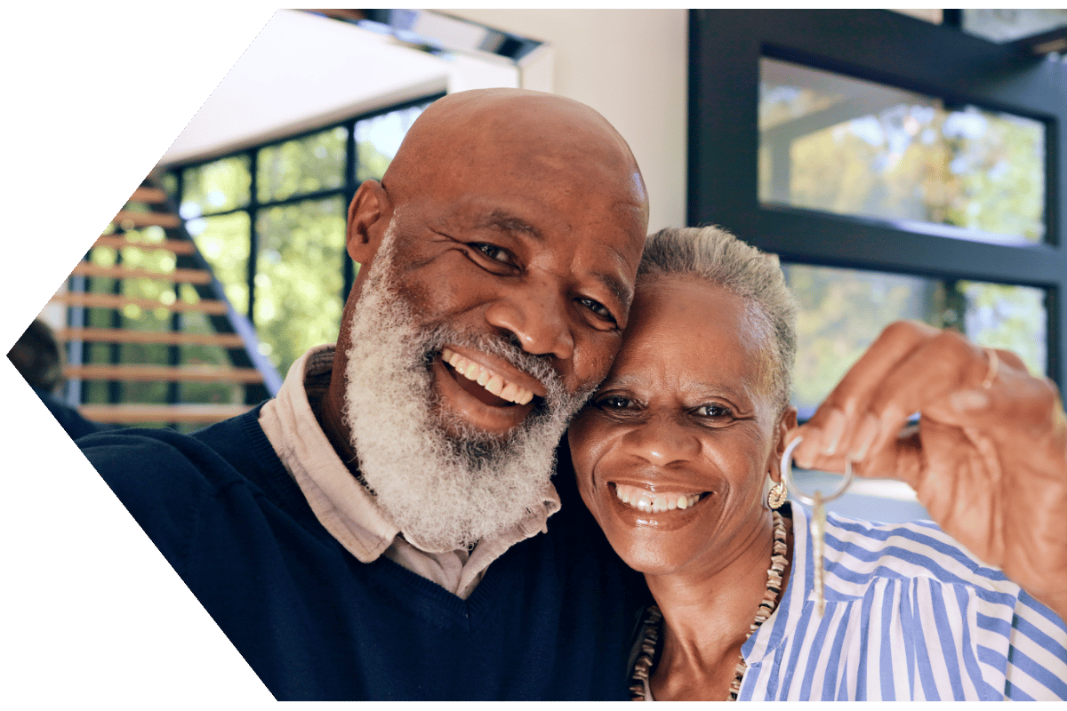 Happy couple moving into a new home with homeowners insurance Happy couple moving into a new home with homeowners insurance
