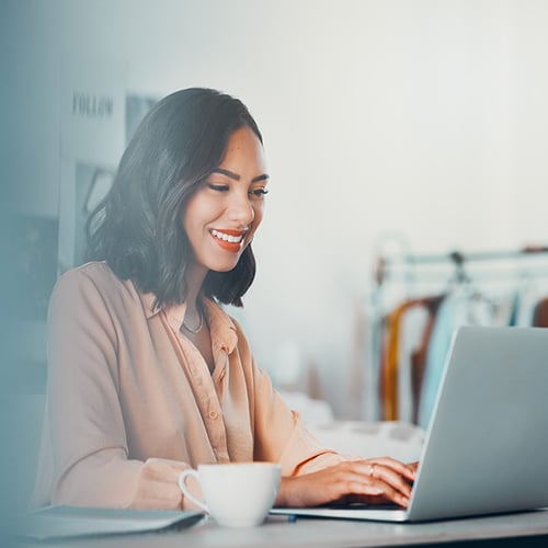 Happy woman using laptop