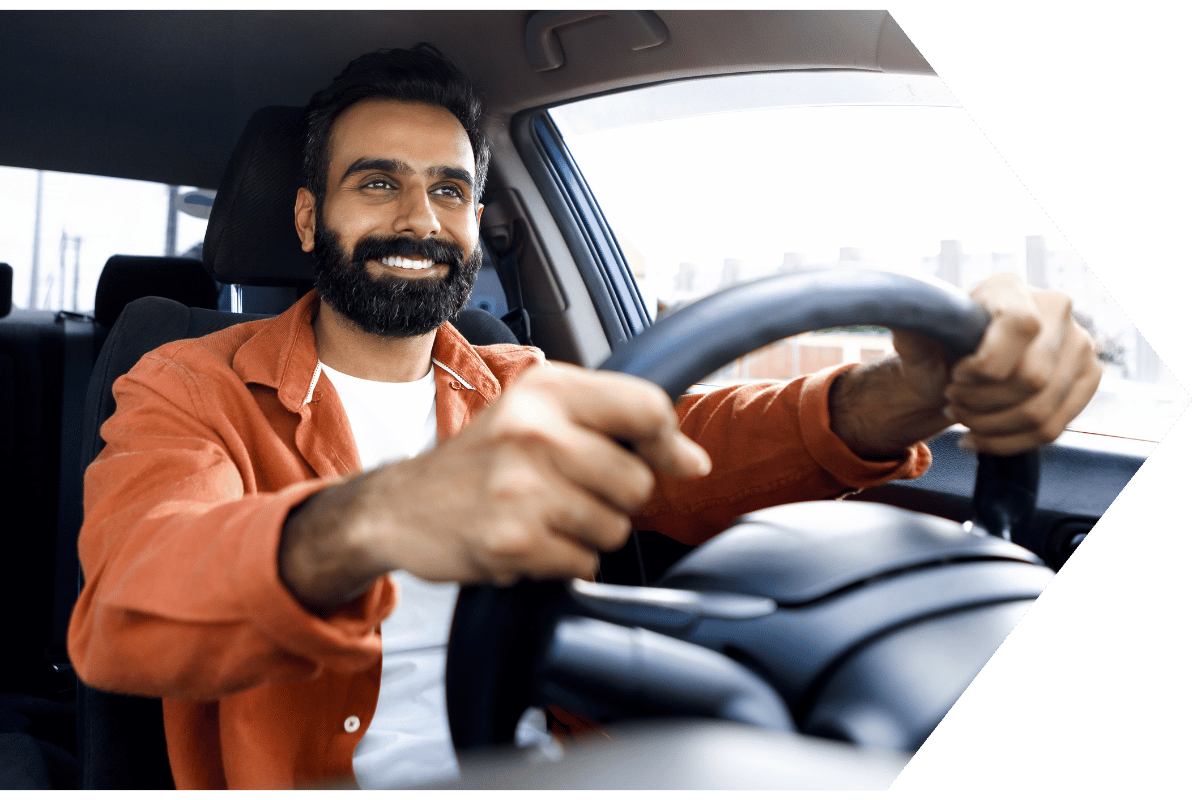 Man driving his care covered with Auto Insurance through Peach State FCU