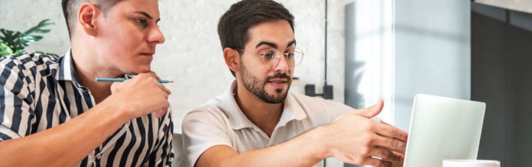 home-loans-do-not-need-to-be-intimidating-two-men-review-financial-numbers-on-laptop