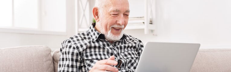 should-i-refinance-my-mortgage-is-a-common-question-peach-state-can-help-elderly-man-on-laptop