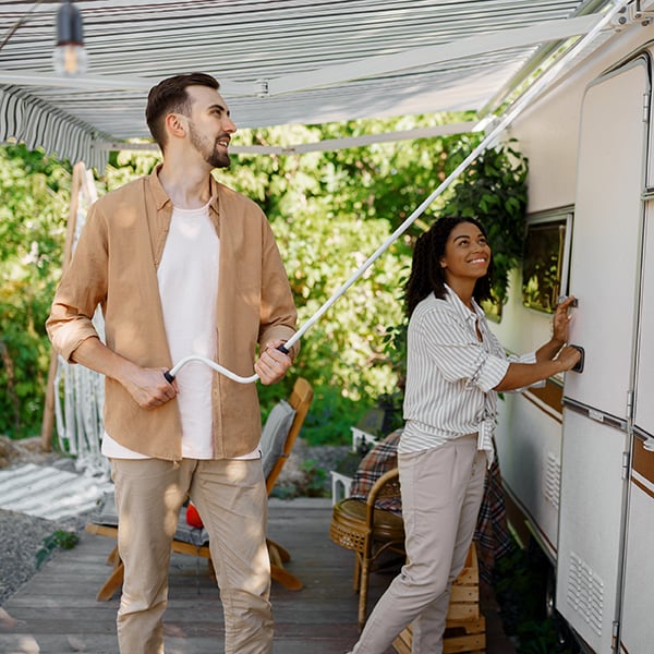 Young couple sets up camper