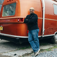 Man poses in front of his RV