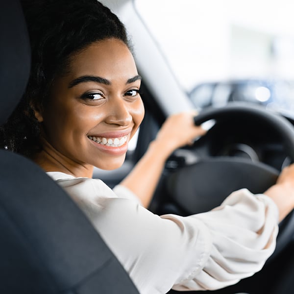 Young woman test drives new car