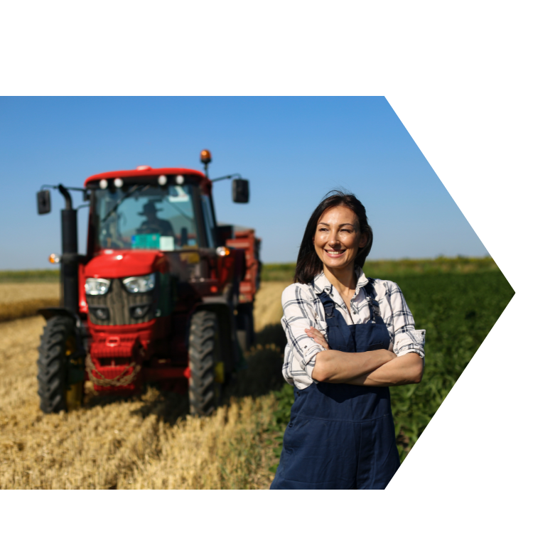 happy farmer in front of tractor in an open field