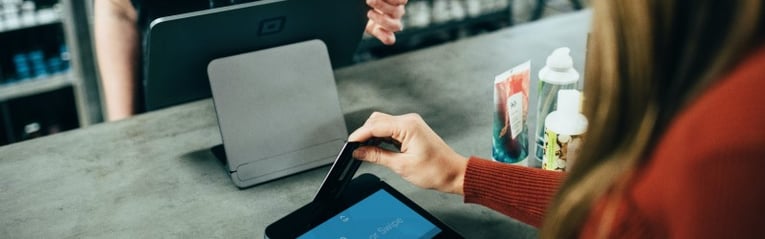 Woman paying for lotions with credit card
