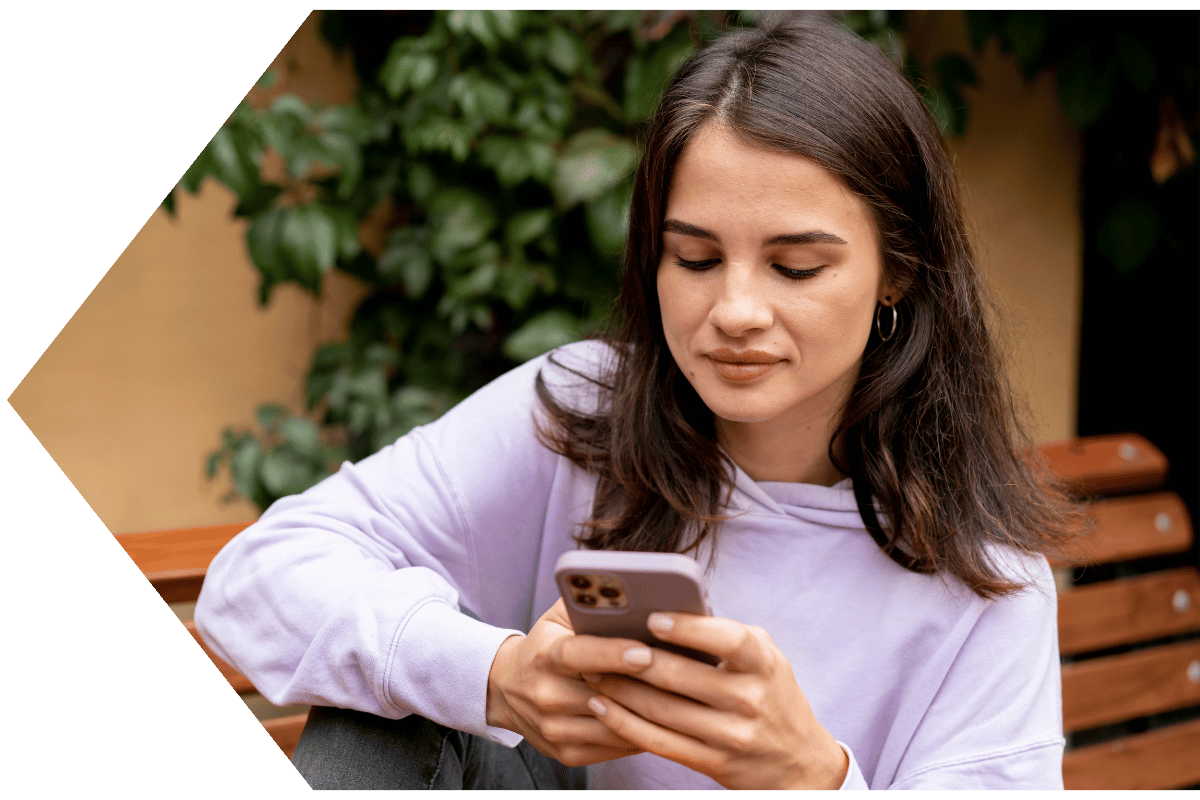 Woman using the Peach State FCU Mobile App to toggle her lost debit card off-1