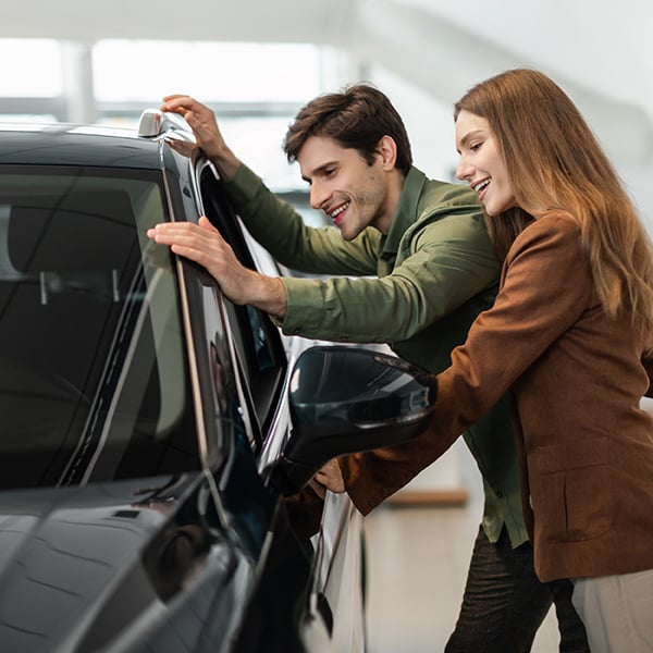 Couple looks at new car together