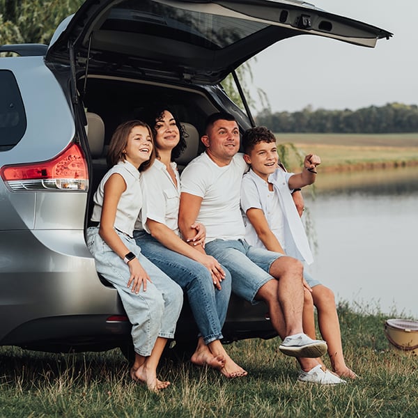 Family enjoys time together in car while on a picnic