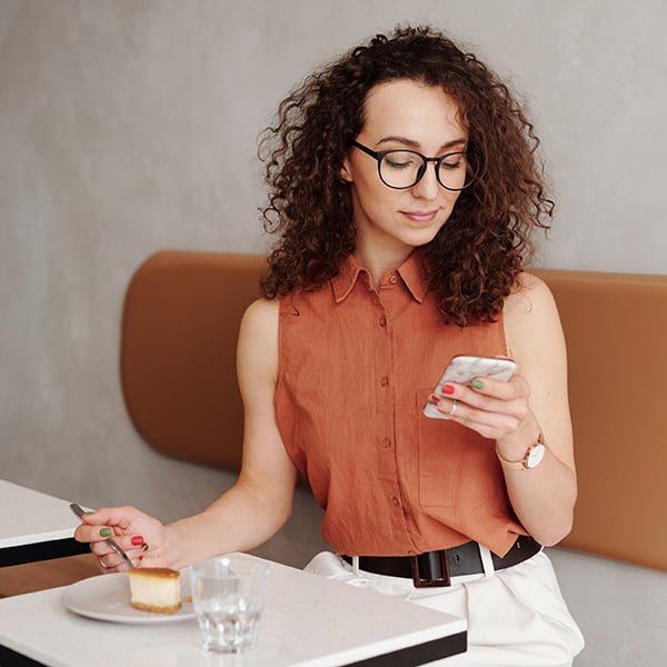 Woman dials Loans by phone while out enjoying cake