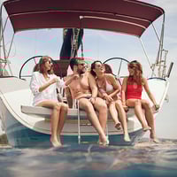 Friends enjoy boat trip on the lake