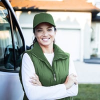 Woman stands in front of company van