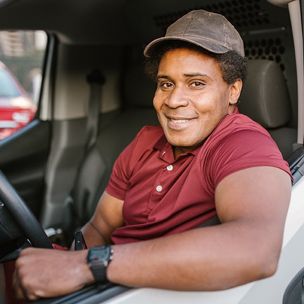 Delivery driver poses in business truck