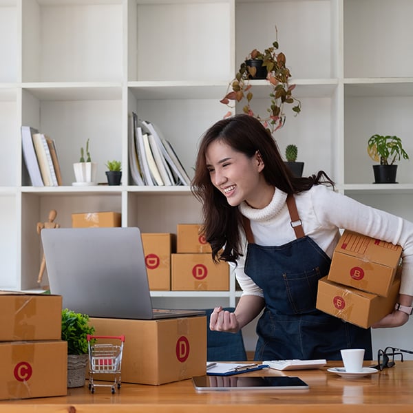 Business woman packages and invoices customers