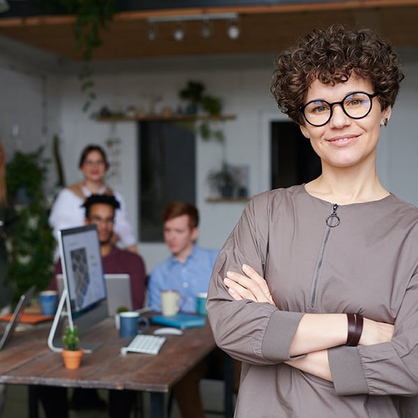 Business owner poses with co-workers